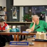 Juneau School Board President Deedie Sorensen and Vice President Emil Mackey discuss milk incident investigation bid and extending food vendors contract with board members Tuesday evening. (Clarise Larson / Juneau Empire)