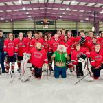 The Juneau-Douglas High School: Yadaa.at Kalé Crimson Bears Varsity hockey team poses with Santa after sleighing the competition during the teams weekend stint in Kodiak. (Courtesy / Judy Campbell)