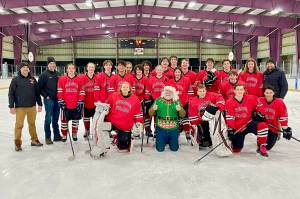 Courtesy / Judy Campbell 
The Juneau-Douglas High School: Yadaa.at Kalé Crimson Bears Varsity hockey team poses with Santa after sleighing the competition during the teams weekend stint in Kodiak.