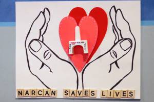 This November 2021 photo shows a poster promoting Narcan, a drug that can reverse opioid overdoses, inside the Juneau Public Health Center. According to statistics shared recently by the state, overdose deaths have been on the rise recently. (Ben Hohenstatt / Juneau Empire File)