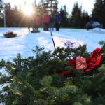 A wreath sits on the ground after being placed during a laying of wreaths ceremony for National Wreaths Across America Day on Saturday afternoon. (Clarise Larson / Juneau Empire)