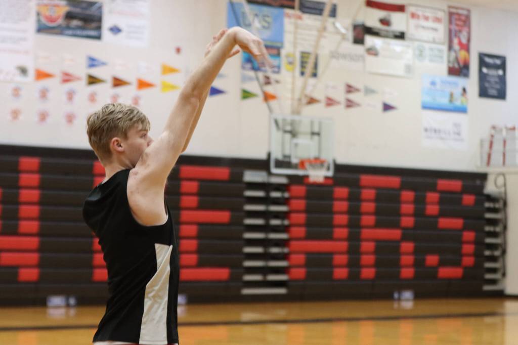 JDHS junior Jonathan Sleppy practices 3-point shots early on Wednesday before practice. (Jonson Kuhn / Juneau Empire)