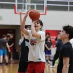 From Left to right, JDHS players seniors Joey Aline, Orion Dybdahl and freshman Brandon Casperson work on free throws during a Wednesday night practice. (Jonson Kuhn / Juneau Empire)