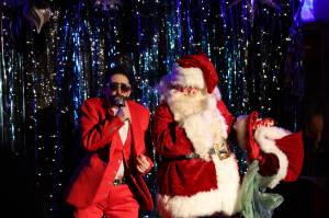 Luke the Duke of Bell and Santa bust a move during their performance Saturday evening at the Alaskan Bar, a part of Juneau Drags Holi-gay Spectacular Ho Ho HOMO. (Clarise Larson / Juneau Empire)