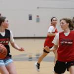 JDHS freshman Gwen Nizich squares off against senior Skylar Tuckwood at a practice Wednesday night with senior Kiyara Miller and Nadia Wilson nearby. (Jonson Kuhn / Juneau Empire)