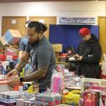 Mark Sabbatini / Juneau Empire 
A volunteer selects donated toys for a recipient during The Salvation Armys food and gift giveaway Saturday at its church and administrative office downtown. St. Vincent de Paul in Juneau is hosting its Adopt-A-Family gift giveaway this week, but had to stop accepting wish lists from families early due to higher-than-usual demand, according to Director Dave Ringle. People interested in helping a family can contact the organization by Thursday,