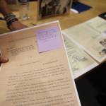 Rebecca Braun shows printed scans of documents her father received from German soldiers before escaping and immigrating to America from Austria before it was annexed by the Nazi regime in 1938. Braun was a speaker at the event, Family Stories  Juneau and the Holocaust, at the Mendenhall Valley Public Library Tuesday evening. (Clarise Larson / Juneau Empire)