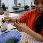 Jeneveva Morris pours oil in an oil roller filled with dried role during a celebration of the winter solstice on Wednesday afternoon at Generations Southeast. According to Mary Aparezuk, Haa Tóoch Lichéesh Coalition, the roses represent strength love and protection. (Clarise Larson / Juneau Empire)