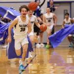 Ben Hohenstatt / Juneau Empire 
Thomas Baxter, a junior, leads the Thunder Mountain High School Falcons through a banner to start the second half of a home win against Petersburg.