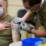 Staff Sgt. Travis Snyder, left, receives the first dose of the Pfizer COVID-19 vaccine given at Madigan Army Medical Center at Joint Base Lewis-McChord in Washington state, Dec. 16, 2020, south of Seattle. U.S. military forces around the world will no longer be required to get the COVID-19 vaccine. The mandate was lifted under an $858 billion defense spending bill passed by Congress and signed into law Friday by President Joe Biden. (AP Photo / Ted S. Warren)