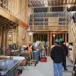People stand at the entrance of the Riverview Senior Living facility in during construction in October. According to Brian Pierce, the project superintendent, occupancy is expected beginning in mid-February of 2023. (Clarise Larson / Juneau Empire)
