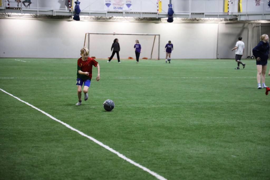 Tanner Schultz, a player for the Big Beard Ballers in the middle school division, practices his shot in between a break in games Monday evening at the Dimond Park Field House. (Clarise Larson / Juneau Empire)