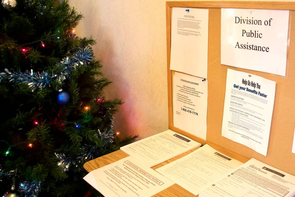 Applications and notifications about changes to benefits line a table at the entrance of the Alaska Division of Public Assistance office in Juneau. The divisions Supplemental Nutrition Assistance Program is months behind processing applications to due to workforce shortages and lingering problems of a cyberattack. (Mark Sabbatini / Juneau Empire)