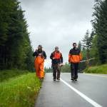 In fall 2021, Quinn Aboudara (left) and crew members Wade Hulstein (center) and Jon Carle walk along a road to access a stream for monitoring work near Klawock Lake. Today, Quinn Aboudara is the Natural Resource Stewardship Coordinator for Shaan Seet Inc., Wade Hulstein is the Klawock Community Catalyst for the SSP at the Klawock Cooperative Association, and Jon Carle is the Indigenous Stewards Coordinator with the Prince of Wales Tribal Conservation District.