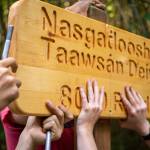 Many hands help to get the work done. Participants of the Alaska Youth Stewards program in Kake install a Lingít/English road sign, a project in partnership with community elders and the U.S. Forest Service.
