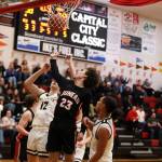 Senior guard Joseph Aline jumps for the ball during the third period during Thursday nights game against South Anchorage High School during the first night of the Princess Cruises Capital City Classic. (Clarise Larson / Juneau Empire)