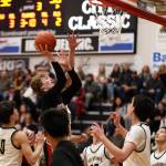Junior guard Sean Oliver pushes through a crowd of players for a layup during the third period during Thursday nights game against South Anchorage High School during the first night of the Princess Cruises Capital City Classic. (Clarise Larson / Juneau Empire)