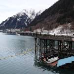 The privately owned 107-foot tugboat named Tagish sits partially below the water next to the National Guard dock south of the downtown cruise ship docks Thursday morning. Recovery plans by the owner are now underway, but are expected to come at a steep price. (Clarise Larson / Juneau Empire)