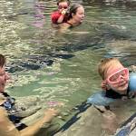 Christal Higdon and daughter Ophelia work on swimming in the deep end during Family Day at the Pool on Saturday at the Dimond Park Aquatic Center. (Jonson Kuhn / Juneau Empire)