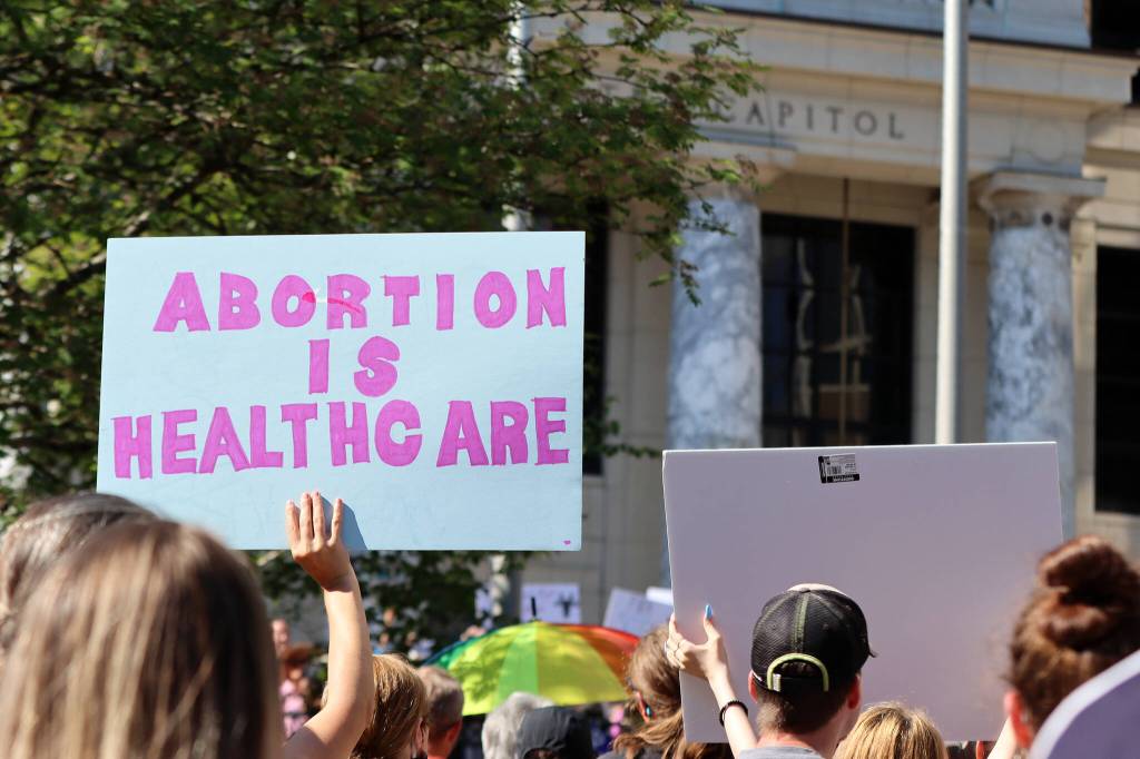 Protesters rally near the Alaska State Capitol following the Supreme Courts decision to overturn Roe v. Wade. While abortion rights are currently protected by the Alaska Constitution, the decision by the U.S. high court ushered in a raft of abortion-banning or access-limiting bills, and the legislative session is likely to see similar efforts. (Ben Hohenstatt / Juneau Empire File)