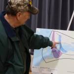 Juneau resident Denny DeWitt looks at the options for a second Douglas crossing during an open house as part of the evaluation process in early December at the Juneau Arts Humanities Council building. (Mark Sabbatini / Juneau Empire)