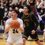 TMHS senior MJ Tupou prepares for a contested shot at the hoop during a game against Service High School. (Ben Hohenstatt / Juneau Empire)