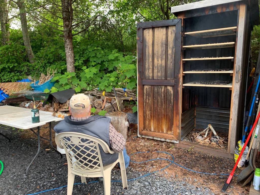Mickey Prescott waits to smoke salmon, Wrangell Alaska. Vivian Faith Prescott photographer