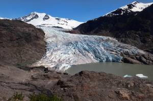 Chunks of ice float on Mendenhall Lake in front of the Mendenhall Glacier on Monday, May 30, 2022, in Juneau, Alaska. A study of all of the world's 215,000 glaciers published on Thursday, Jan. 5, 2023, finds even if with the unlikely minimum warming of only a few tenths of a degrees more, the world will lose nearly half its glaciers by the end of the century. With the warming we're now on track to get, the world will lose two-thirds of its glaciers and overall glacier mass will drop by one-third while sea level rises 4.5 inches just from melting glaciers. (AP Photo / Becky Bohrer)