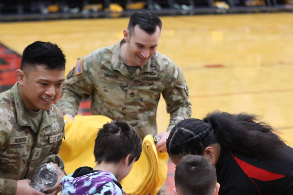 Members of the Alaska Army National Guard, Staff Sgt. Sean Smack and Private First Class Kyrell De La Rosa, throw shirts and towels into the crowd during halftime on Thursday nights JDHS game against Service High School. (Jonson Kuhn / Juneau Empire)