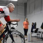 Reed Stoops bikes stationary with other athletes during a High Cadence Triathlon Team workout at the Dimond Park Field House Thursday evening. Many athletes are still deciding what to do after it was announced in mid-December the Ironman Group announced its decision to cancel the Ironman Alaska races for 2023 and 2024.