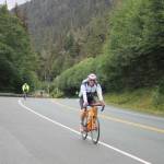 Clarise Larson / Juneau Empire 
A racer smiles mid way through the 112-bike portion of the Ironman Alaska in August 2022.