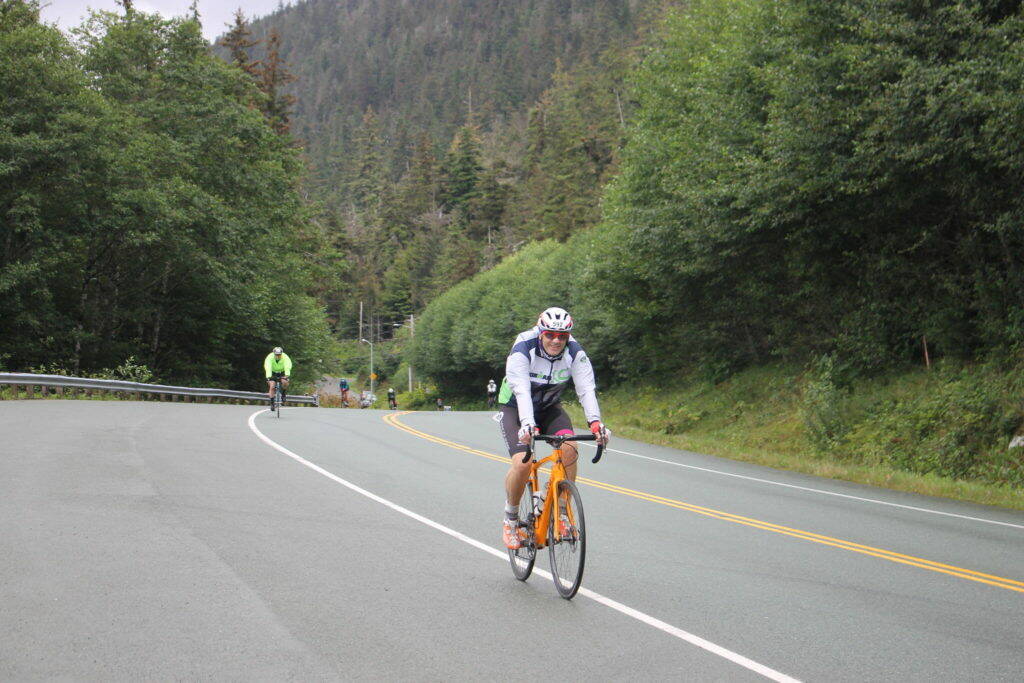 Clarise Larson / Juneau Empire 
A racer smiles mid way through the 112-bike portion of the Ironman Alaska in August 2022.