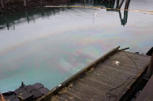 The privately owned 107-foot tugboat named Tagish sits submerged in the water next to the National Guard dock south of the downtown cruise ship docks Tuesday morning. (Clarise Larson / Juneau Empire)