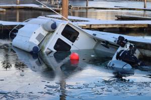 A boat sinks at Andrews Marina inside Fishermans Bend on Tuesday. (Jonson Kuhn / Juneau Empire)