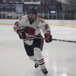 Senior assistant captain Brandon Campbell chases the puck during the first period of Juneau-Douglas High School: Yadaa.at Kalé Crimson Bears hockey game against the Soldotna High School Stars on Saturday. (Clarise Larson / Juneau Empire)
