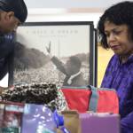 Sherry Patterson and her son Michael sort through the large pile of donations received on Monday as part of the Black Awareness Association of Juneaus annual collection drive at St. Pauls Catholic Church. (Jonson Kuhn / Juneau Empire)