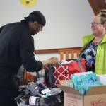 Abby OBrien brings in her boxes of donations for Michael Patterson and the Black Awareness Association of Juneau during their annual collection drive on Monday at St. Pauls Catholic Church. This year items were being raised for Shéiyi X̱aat Hit (Spruce Root House) and Glory Hall shelter. (Jonson Kuhn / Juneau Empire)