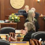 Juneau Democratic state Reps. Sara Hannan, center left, and Andi Story, center right, chat with fellow lawmakers minutes before the House was called to order at 2:05 p.m. Tuesday at the Alaska State Capitol. (Mark Sabbatini / Juneau Empire)