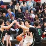 JDHS senior Orion Dybdahl takes the ball down court while being closely guarded by two defenders on Wednesday nights game. Dybdahl led the Crimson Bears in scoring with 19 points. (Jonson Kuhn / Juneau Empire)