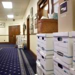 Moving boxes are stacked outside the offices of state Rep. Sara Hannan, D-Juneau, and former House Speaker Louise Stutes, a Kodiak Republican, on the second floor of the Alaska State Capitol on Wednesday morning following their demotion to minority status after a Republican-led majority excluding Stutes was named Tuesday. As minority members, they will have no official say on the location of their new offices. (Mark Sabbatini / Juneau Empire)