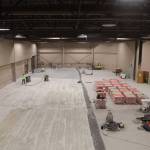 A handful of workers clean the floors of the Centennial Hall ballroom Wednesday evening as renovations continue. According to projects manager, the renovation are expected to be completed in early August. (Clarise Larson / Juneau Empire)