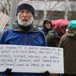 Paul Desloover displays a sign in opposition to Mondays anti-abortion rally at the State Capitol. (Jonson Kuhn / Juneau Empire)