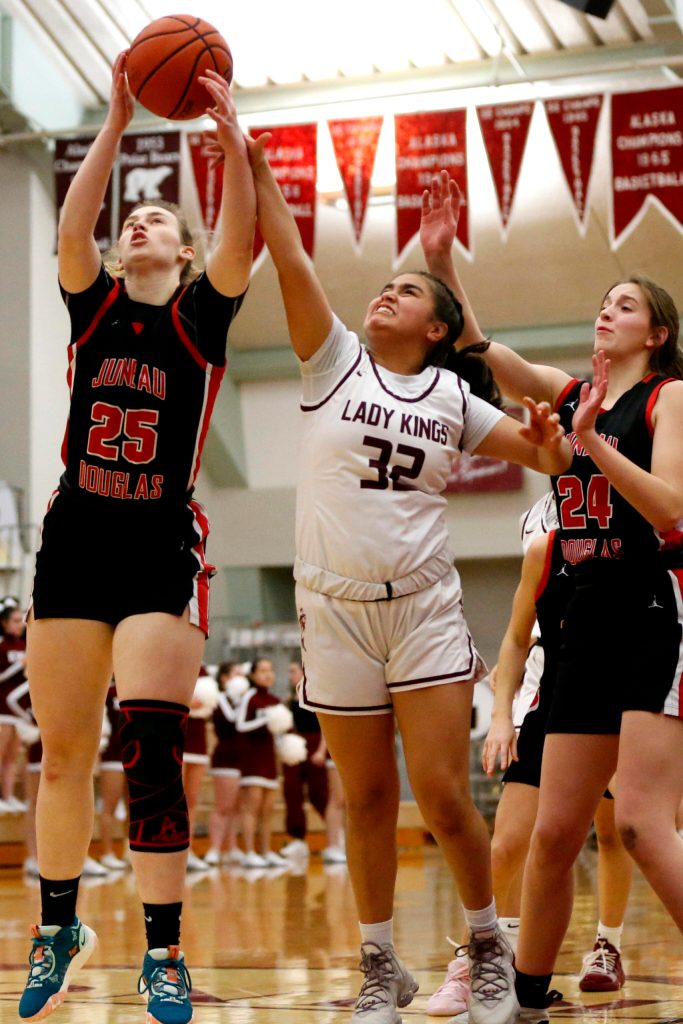Juneaus Ashley Laudert (25), Kayhis Kylie Brendible (32), and Juneaus Mila Hargrave (24) go up for a rebound on Friday at Ketchikan High School. Juneau won 40-33. (Christopher Mullen / Ketchikan Daily News)
