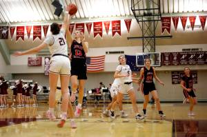 Kayhis Lindsay Byron (21) tries to block Juneaus Skylar Tuckwood (13) as she attempts a layup Friday at Ketchikan High School. Juneau won 40 to 33. Photo by Christopher Mullen Ketchikan Daily News
