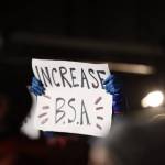 A protester holds a sign advocating for an increase in the states base student allocation during a rally at the steps of the Alaska State Capitol Monday evening. (Clarise Larson / Juneau Empire)
