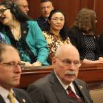 Katie Botz, center rear, watches state Sen. Jesse Kiehl of Juneau, lower left, chat with a fellow lawmaker before Gov. Mike Dunleavys State of the State speech Monday night. Kiehl was among several legislators cited by Dunleavy as critical to the passage of a bill Botz was advocating to reform the states consent law. (Mark Sabbatini / Juneau Empire