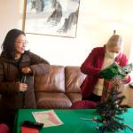 Katie Botz, left, gives state Rep. Andi Story of Juneau a present during an open house hosted by the local legislative delegation in December at the Alaska State Capitol. (Mark Sabbatini / Juneau Empire)