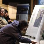 Jonson Kuhn / Juneau Empire 
Juneau residents view informational boards set up throughout the Mendenhall Glacier Visitors Center on Tuesday during an open house to provide an overview of alternatives proposed for changes to the recreation area.