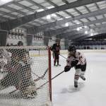 Clarise Larson / Juneau Empire 
Senior assistant captain Anna Dale attempts to stuff the net during a home game between Juneau-Douglas High School: Yadaa.at Kalé Crimson Bears Varsity hockey team and the Kenai Central Kardinals at the Treadwell Arena in early December.