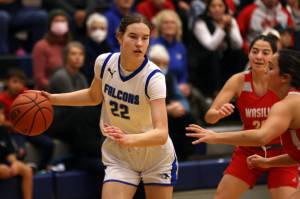 TMHS sophomore Kerra Baxter (22) dribbles while surveying the court during a loss to Wasilla. (Ben Hohenstatt / Juneau Empire)